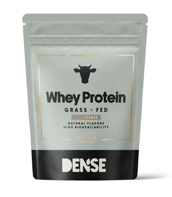 DENSE Grass-Fed Whey Protein Chocolate comes in a silver and black pouch with a cow icon, featuring natural flavors, high bioavailability, and offering an organic, low-carb protein powder option.