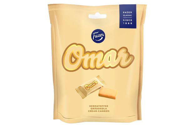 A beige Fazer Omar bag shows the brand and product name in large letters, with images of Finnish soft fudge below: one caramel unwrapped and another wrapped.