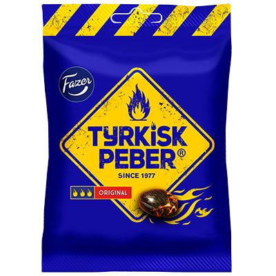 A blue bag of Fazer Tyrkisk Peber Original by Fazer, featuring a yellow diamond label with flames, the brand name, and a burning salty liquorice candy illustration. Bold yellow warning stripes accent the top.