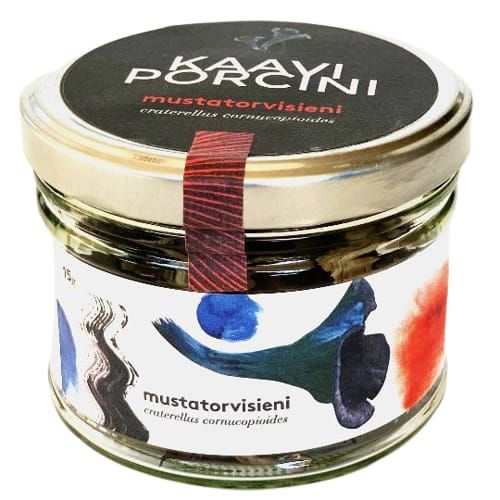 A glass jar with a black lid contains Kaavi Porcini Dried Black Trumpet mushrooms, featuring artistic colorful brushstroke label designs and showcasing Finnish flair.