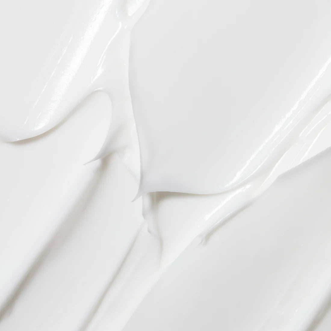 A close-up of Lumene Nordic Hydra Moisture Balm by Lumene, featuring smooth, white cream with triple hyaluronic acid, spread in soft waves to showcase its deep hydration benefits.