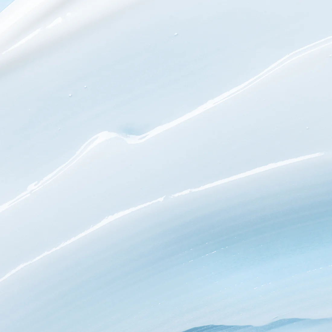 A smooth, light blue and white creamy texture with gentle waves and subtle ridges, like Lumene Nordic Hydra Moisture Conditioner by Lumene spread across a surface.