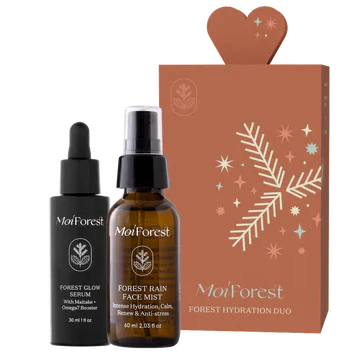 The Moi Forest Forest Hydration Duo is displayed in front of a brown gift box decorated with white botanicals and a heart-shaped top.