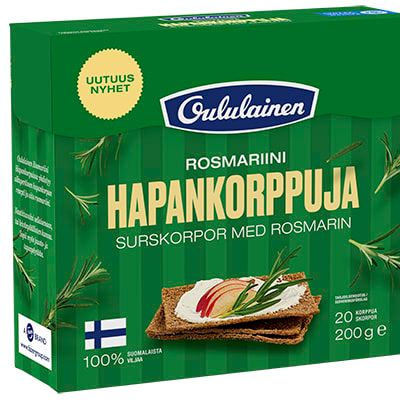 A green box of Oululainen Rye Crisp Bread Rosemary displays Finnish and Swedish text, an image of this wholegrain snack with sliced radish and herbs on top, plus rosemary sprigs featured on the packaging.