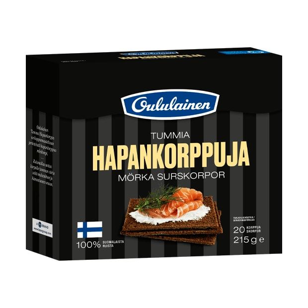 A box of Oululainen Rye Crisp by Oululainen features crispbread topped with salmon and dill on the front. The high fiber snack comes in black packaging with white and brown text, plus a Finnish flag.