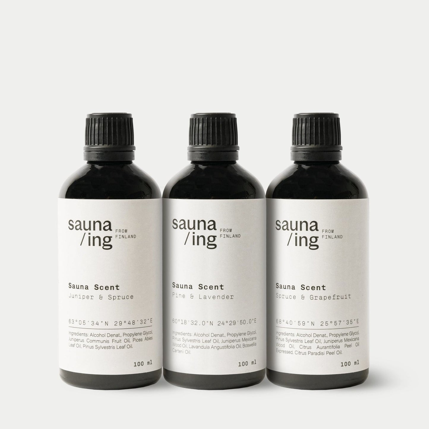 Three black bottles of sauna/ing Sauna Scent Juniper & Spruce by sauna/ing are displayed side by side on a white background. Each bottle features unique fragrances, such as spruce and juniper, for an authentic Finnish sauna experience.