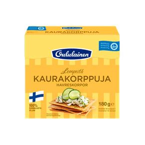 A yellow 180g box of Oululainen Oat Crisp Bread features high-fibre crackers topped with cream, cucumber, and herbs. The packaging shows the Finnish flag and states it is proudly made in Finland.
