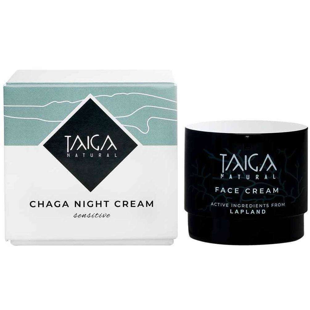 A box of Taiga Cosmetics Chaga Night Cream Sensitive stands next to a dark jar labeled Taiga Cosmetics Natural Face Cream. Both creams are ideal for sensitive skin and nourish dry skin.