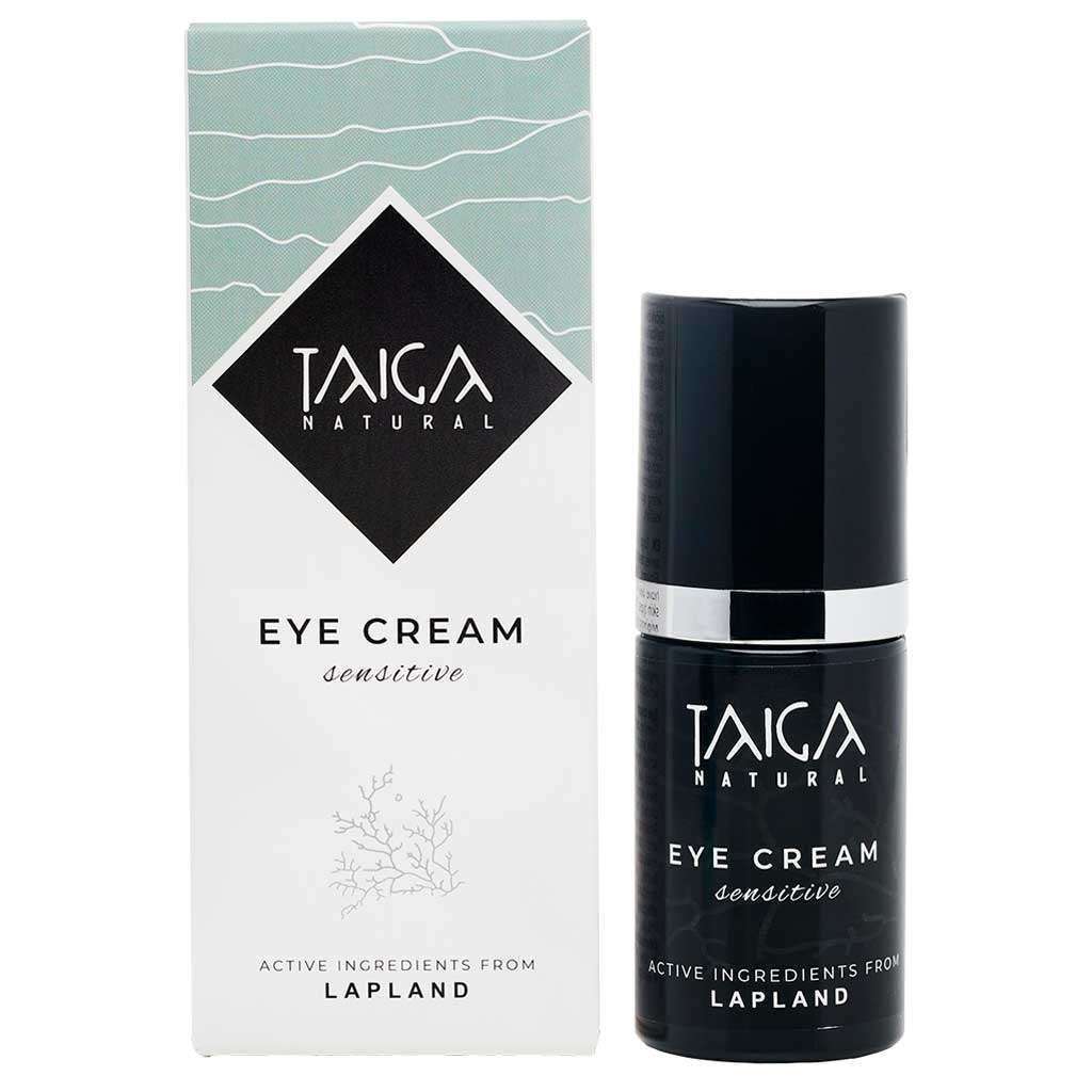A bottle of Taiga Cosmetics Eye Cream Sensitive is displayed beside its box, both featuring “Active ingredients from Lapland” and a minimalist black-and-white design—ideal for sensitive skin and formulated to reduce dark circles.