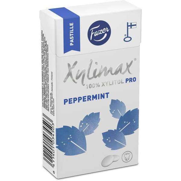 A box of Fazer Xylimax Peppermint Full Xylitol Pastilles features blue leaf designs, marked 100% Xylitol Pro and Peppermint. Icons emphasize tooth-friendly dental benefits and Finnish origin. Brand: Fazer.