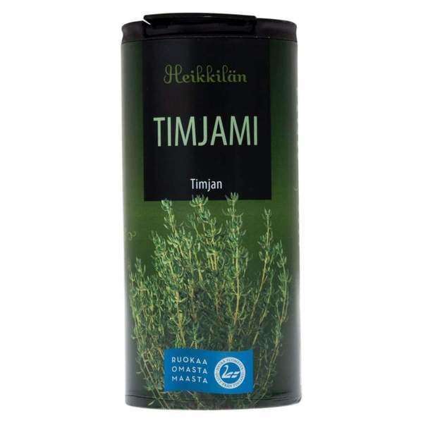 A cylindrical container of Heikkilä's Thyme, ideal for seasoning or herb blends, features thyme sprigs and green labeling.