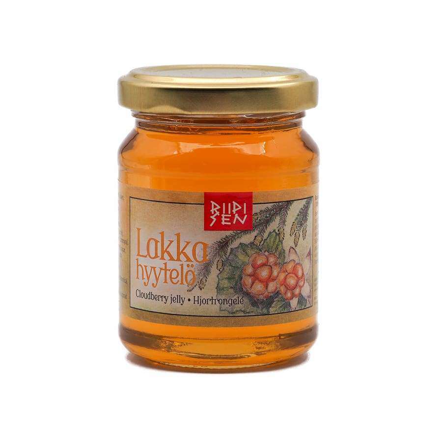 A glass jar of Riipisen Cloudberry Jelly with a golden metal lid and an illustrated label—ideal for pairing with meat and poultry dishes.
