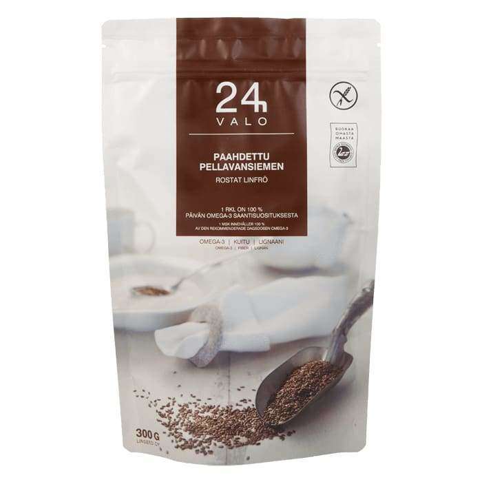 A resealable white and brown 300g package labeled Valo24h Roasted Whole Flaxseed features Finnish text, a spoon with flaxseeds image, and highlights its richness in soluble fiber on the front.