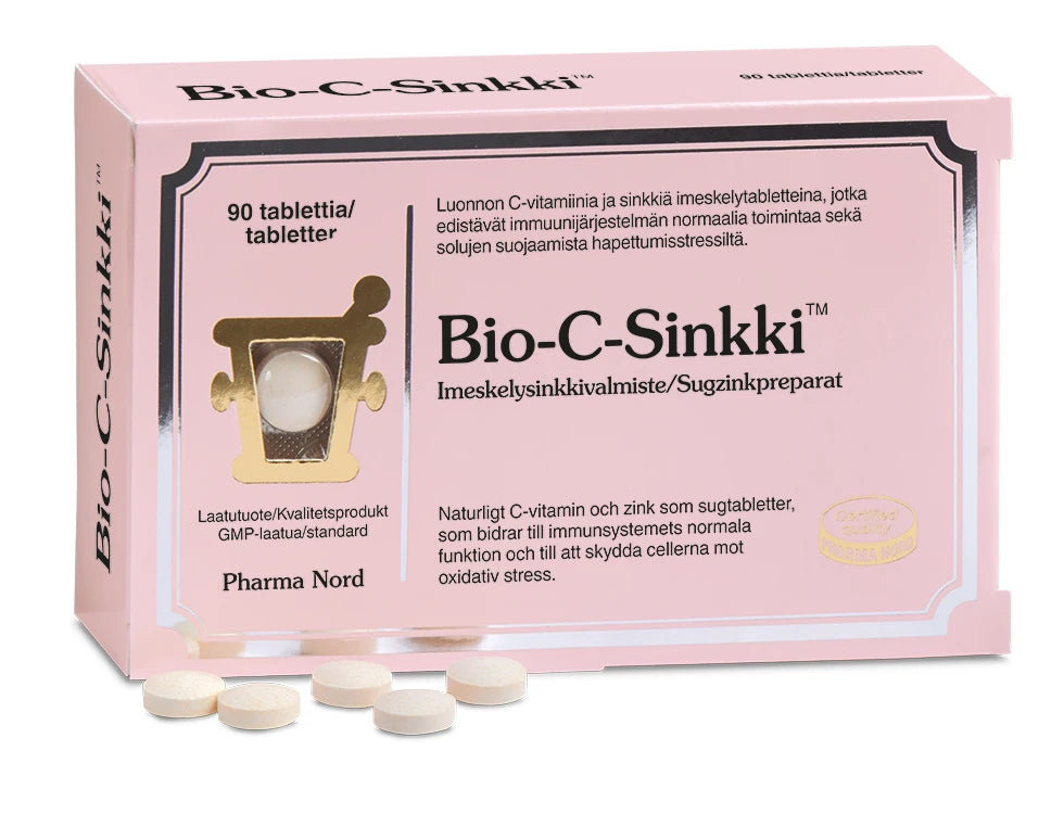 A pink box of Pharma Nord’s Bio-C-Zinc tablets, supporting the immune system, with several round tablets in front. The packaging displays text in Finnish and Swedish.