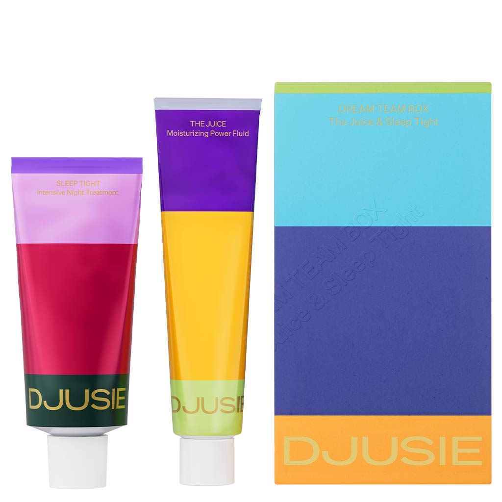 Two colorful tubes from Djusie—one red and purple, the other yellow and blue—stand by the Djusie Dream Team Box, offering moisturizing power fluid and nourishing night treatment formulas.
