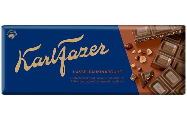 A blue and brown Fazer wrapper with gold lettering showcases milk chocolate squares and chopped hazelnuts. The text reads "Fazer Chopped Hazelnuts Milk Chocolate.