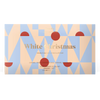 A boxed double caramel chocolate bar labeled 'White Christmas' with a geometric pattern in pale blue, peach, and muted red on a white background.
