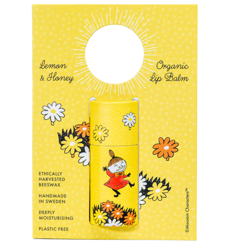 The Gustaf & Linnea Moomin Lipbalm Little My features eco-friendly yellow packaging with Little My among flowers. Handmade in Sweden, this organic, plastic-free balm uses ethically sourced beeswax for deep moisture.