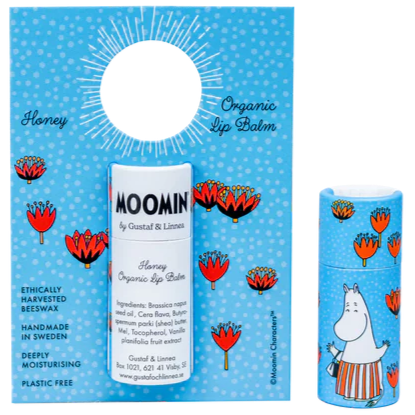 The Gustaf & Linnea Moomin Lipbalm Moominmamma is a honey-flavored, eco-friendly balm in blue packaging with red flowers and a Moomin character, featuring ethically sourced beeswax and plastic-free packaging.