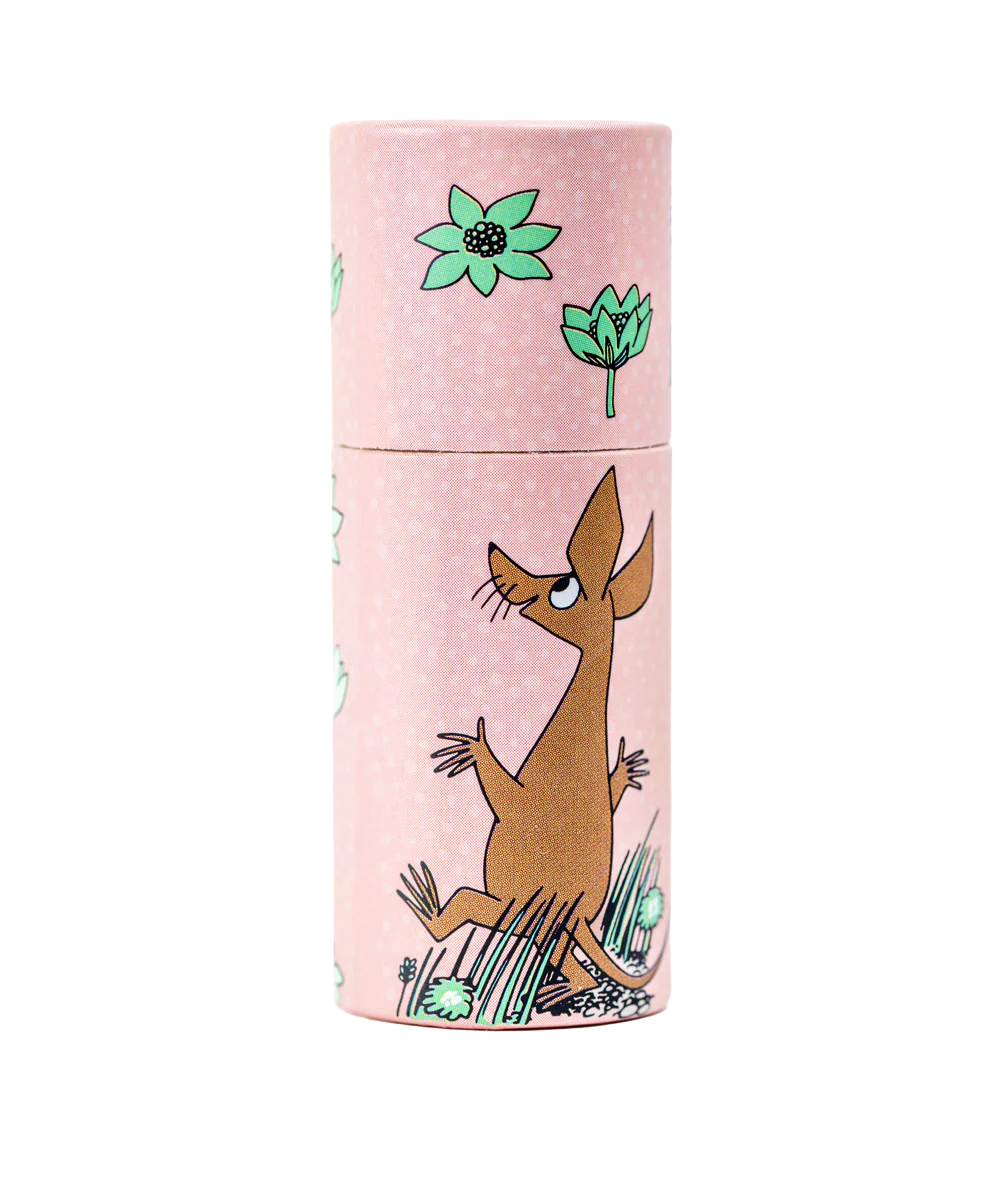 The Gustaf & Linnea Moomin Lipbalm Sniff is an eco-friendly pink cylindrical lip balm featuring cartoon artwork of Sniff, a brown animal, among green flowers and grass.