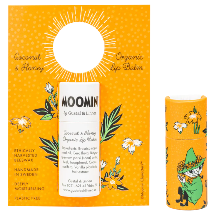 The Gustaf & Linnea Moomin Lipbalm Snufkin features an orange, flower-decorated package and tube with Snufkin, and “Coconut & Honey Organic Lip Balm—handmade in Sweden, deeply moisturizing, plastic-free, eco-friendly.”.