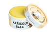A round container of Gustaf & Linnea Moominmammas Marigold Balm with a partially open lid shows a Moomin character in a flower crown and striped scarf. The yellow natural skin balm comes in eco-friendly Gustaf & Linnea packaging.