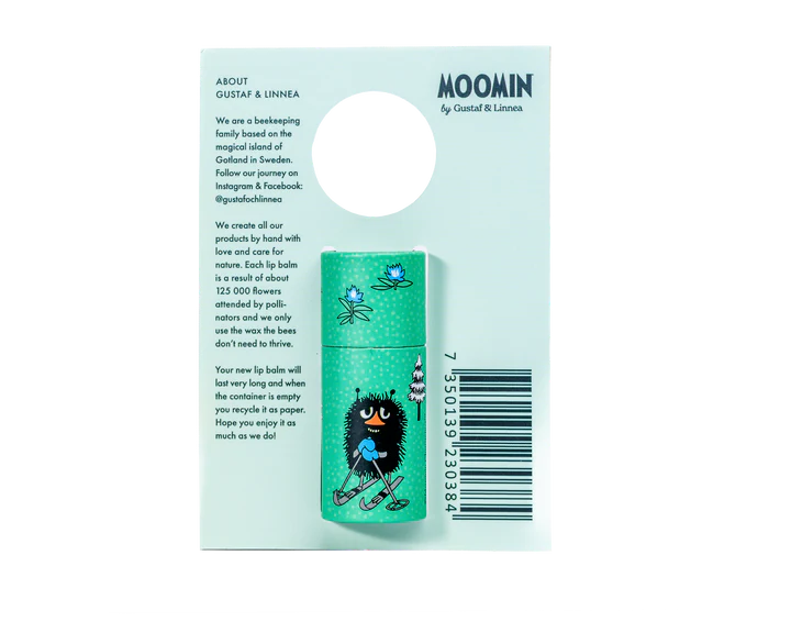 The Gustaf & Linnea Moomin Lipbalm Stinky features a turquoise tube with Moomin artwork, attached to a hanging card with Swedish beeswax details, bee illustrations, and a display cut-out at the top.
