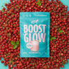 Blue package labeled 'HEEA! Boost & Glow' surrounded by red berries on a blue background