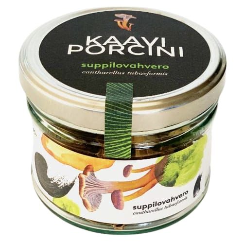 Kaavi Porcini Dried Tube Chanterelle by Kaavi Porcini comes in a glass jar with a metal lid. The label has illustrations of Finnish mushrooms and text in Finnish and Latin, including "suppilovahvero" (Cantharellus tubaeformis).
