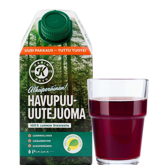 A green carton of Kari's Pine Extract Drink 6-pack stands beside a clear glass of dark red juice. The box features Finnish pine forest imagery and displays organic and health badges, highlighting its antioxidant-rich pine extract.