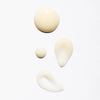 Four drops of Lumene Nordic-C Glow Renew Night Serum, a creamy beige formula with arctic cloudberry and vitamin C, are shown on a white background in various round and teardrop shapes.