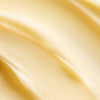 Close-up of creamy, smooth, pale yellow Lumene Nordic-C Strength & Shine 2-in-1 Hair Mask by Lumene, featuring a soft, wavy texture and enriched with vitamin C.
