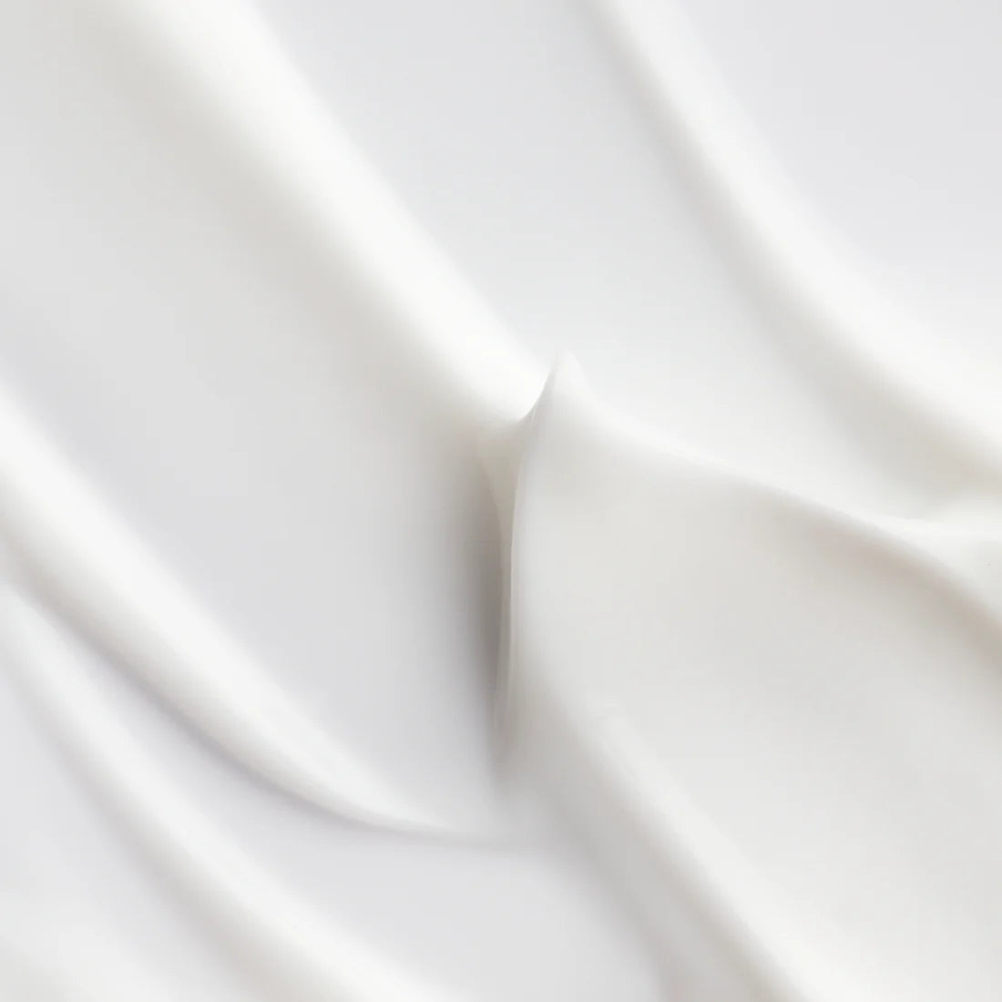Smooth white fabric with gentle, flowing folds and soft shadows evokes the elegant, silky texture and deep hydration delivered by Lumene Nordic Hydra Hydration Recharge Overnight Cream from Lumene.