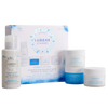 Four Lumene Nordic Hydra skincare products (oat milk oil cleanser, overnight cream, HA moisturizer, and water gel) are shown with their blue and white Lumene Nordic Hydra Travel Kit box.