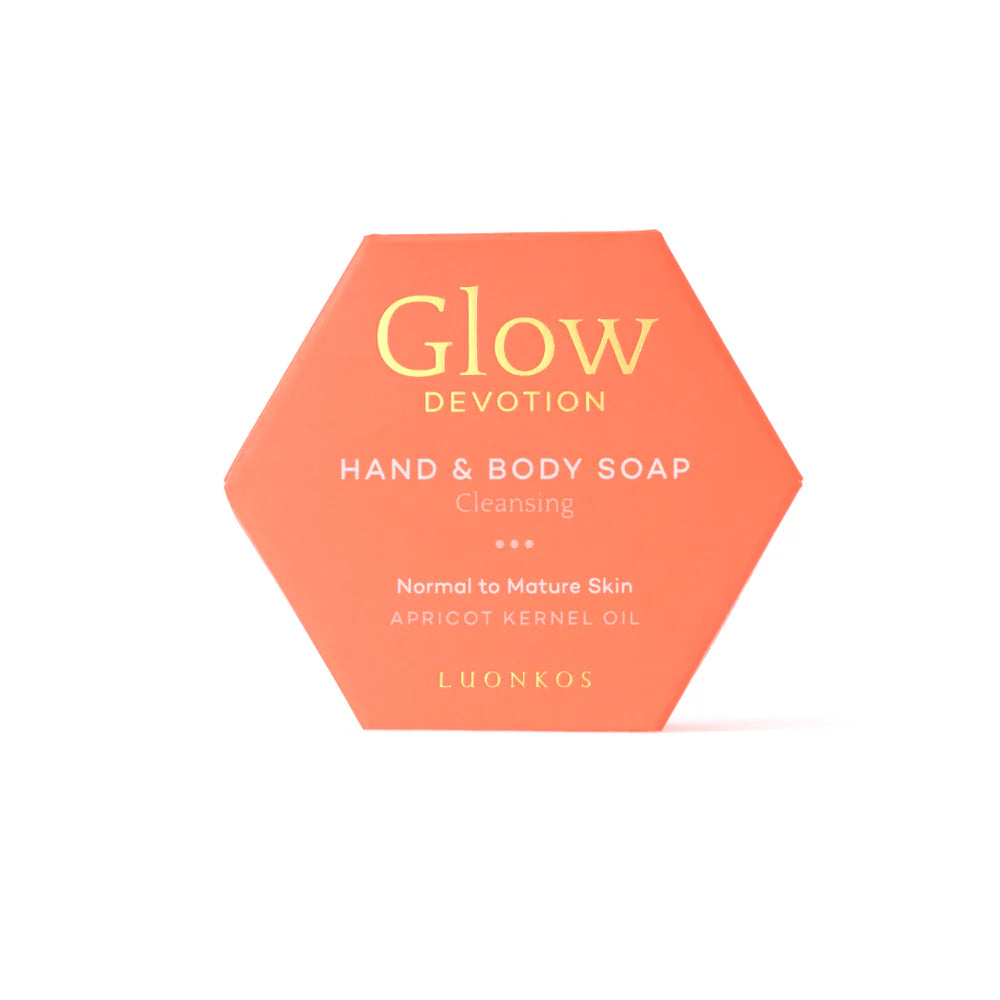 Luonkos Glow Devotion Hand & Body Soap—a vegan bar for normal to mature skin, enriched with apricot kernel oil—offers gentle, natural cleansing in its signature hexagonal orange box.