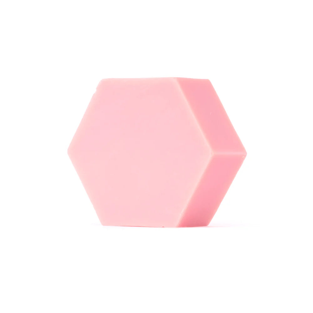 The Luonkos Glow Devotion Hand & Body Soap, a solid pink hexagonal vegan bar, is displayed against a plain white background.