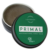 A round tin of Luonkos Primal Multifunctional Forest Balm with a green lid sits partly open, showing the light brown balm inside. Perfect for eczema-prone skin, its label displays white text and Luonkos' small tree logo.