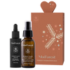 The Moi Forest Forest Hydration Duo is displayed in front of a brown gift box decorated with white botanicals and a heart-shaped top.