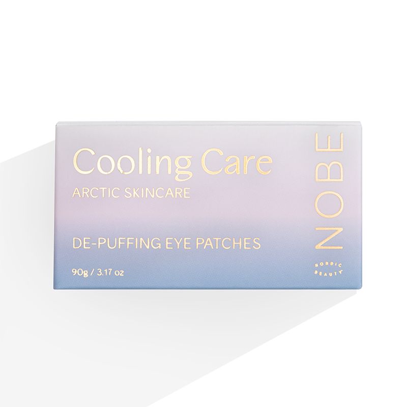 A 90g pastel-gradient box labeled "NOBE Cooling Care De-Puffing Eye Patches" by NOBE Nordic Beauty offers cooling under-eye hydration with its minimalist design.