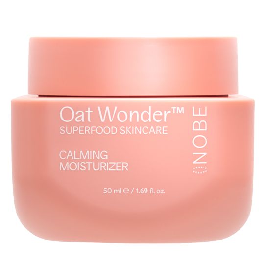 A pink jar of NOBE Oat Wonder® Calming Moisturizer by NOBE Nordic Beauty, featuring Fazer Oat Oil for sensitive skin, contains 50 ml (1.69 fl. oz.) of vegan moisturizer and is shown against a white background.