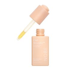 A beige dropper bottle labeled NOBE Oat Wonder® Nourishing Face Oil from NOBE Nordic Beauty, with the cap off and yellow oil visible in the dropper.