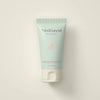 A tube of MoiForest Nurturing Forest Dust moisturizer, featuring a pale mint green body and a white flip-top cap, centered against a warm off-white background.