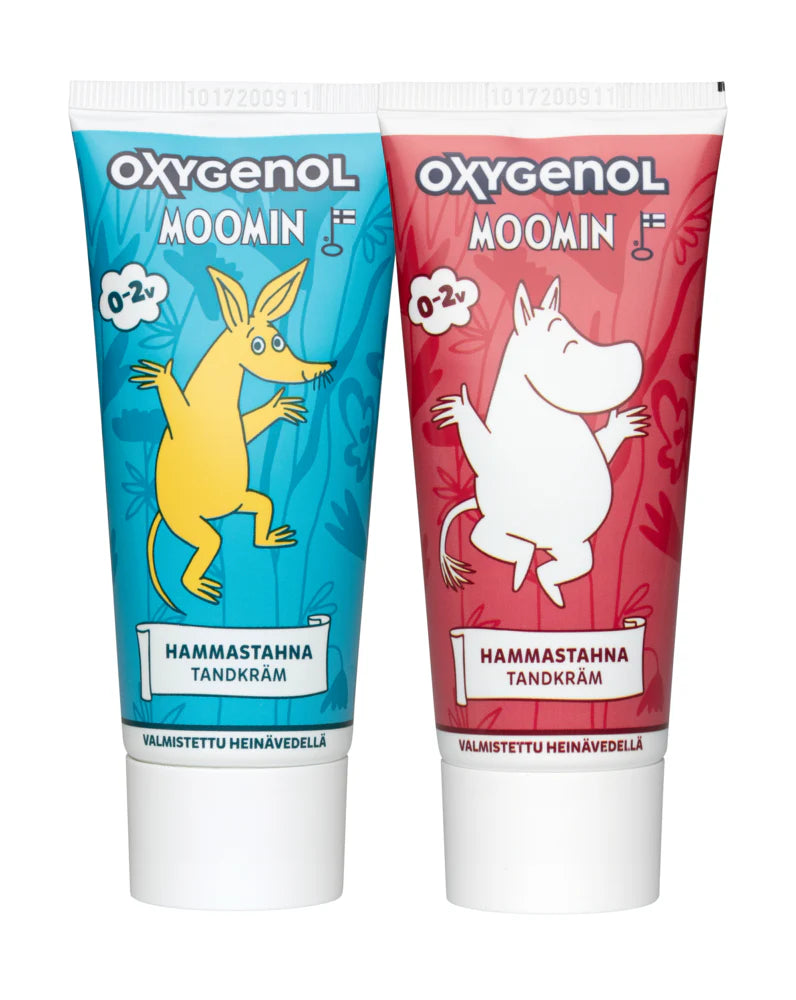 Two Oxygenol Moomin Baby Toothpaste 0+ tubes: one blue featuring Sniff, one red with Moomintroll. Both are xylitol toothpaste for babies, with Finnish text on each tube.
