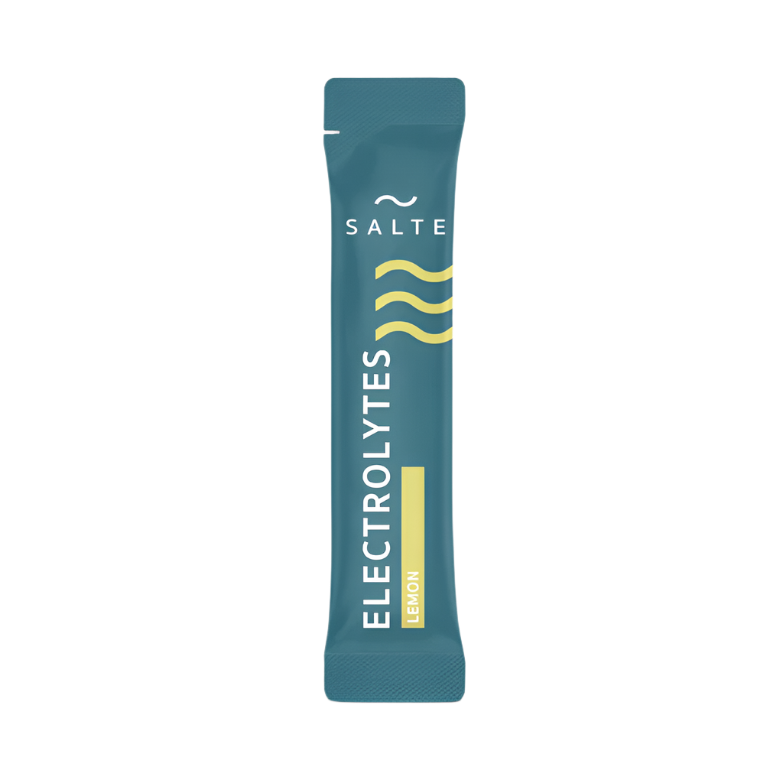 A teal, single-serve SALTE Electrolytes Lemon packet with three yellow wavy lines and sugar-free hydration powder is shown on a plain light background.