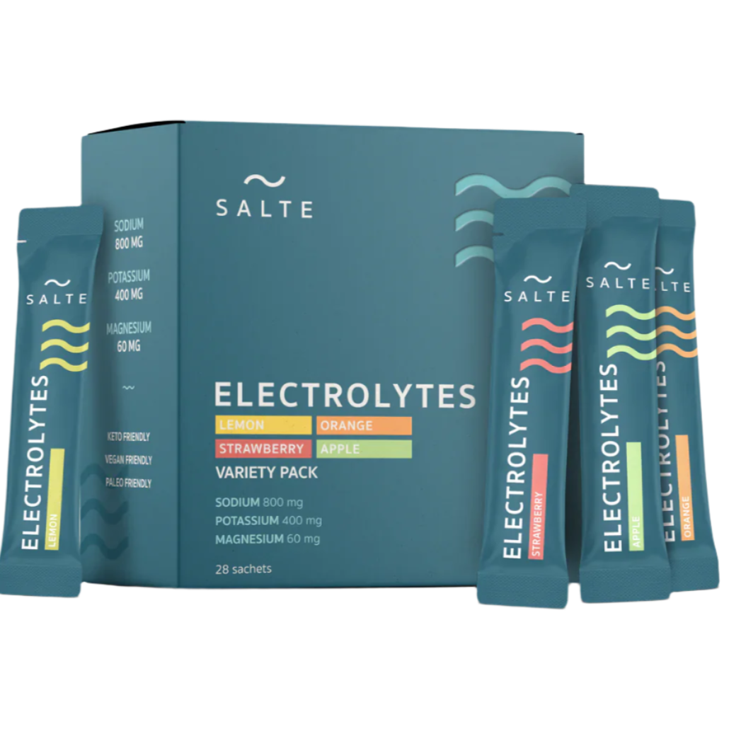 A box of SALTE Electrolytes Variety Pack is shown with four sachets—lemon, orange, strawberry, and apple flavors—displayed in front. The packaging displays nutrient details and keto electrolytes info. Brand: SALTE.