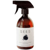 A brown spray bottle labeled SEES Cleaning Spray for the Kitchen and Bathroom by SEES Company—an ecological, plant-based cleaner with a minimalist black and white design. Suitable for both kitchen and bathroom surfaces.