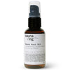 A brown bottle of sauna/ing Sauna Hair Oil with a black pump and white label, featuring Strengthening Golden Kelp & Nourishing Almond for heat protection and frizz control. The label lists ingredients, location coordinates, and the sauna/ing brand.
