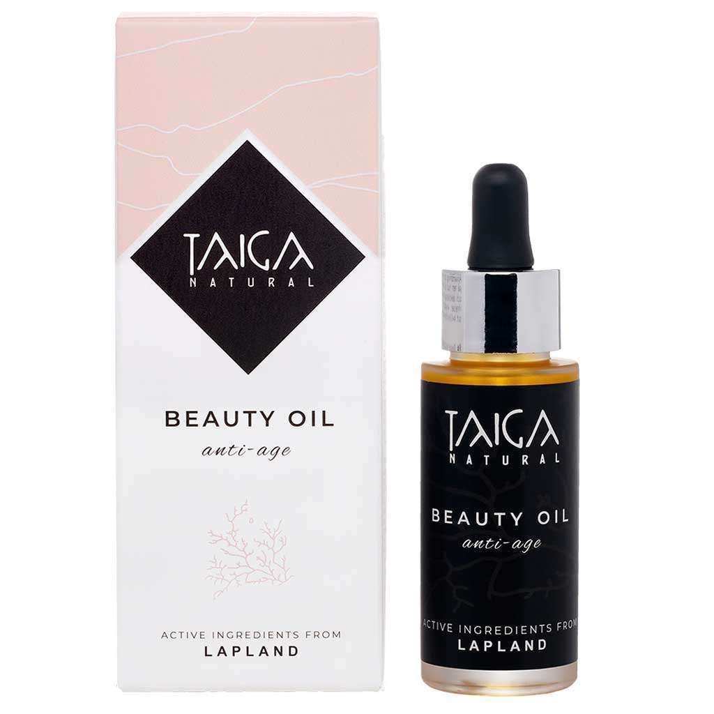 A bottle of Taiga Cosmetics Beauty Oil Anti-Age with a dropper cap sits beside its white and pink box. The label highlights anti-aging and active ingredients from Lapland, such as sea buckthorn oil. Brand: Taiga Cosmetics.