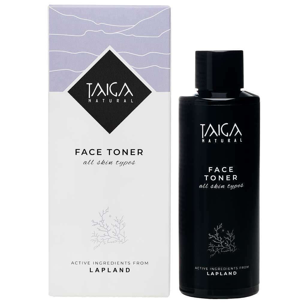 A black bottle of Taiga Cosmetics Face Toner All Skin Types stands beside its white and lavender box, both showcasing the Taiga Cosmetics brand and featuring natural Lapland ingredients for gentle cleansing of all skin types.