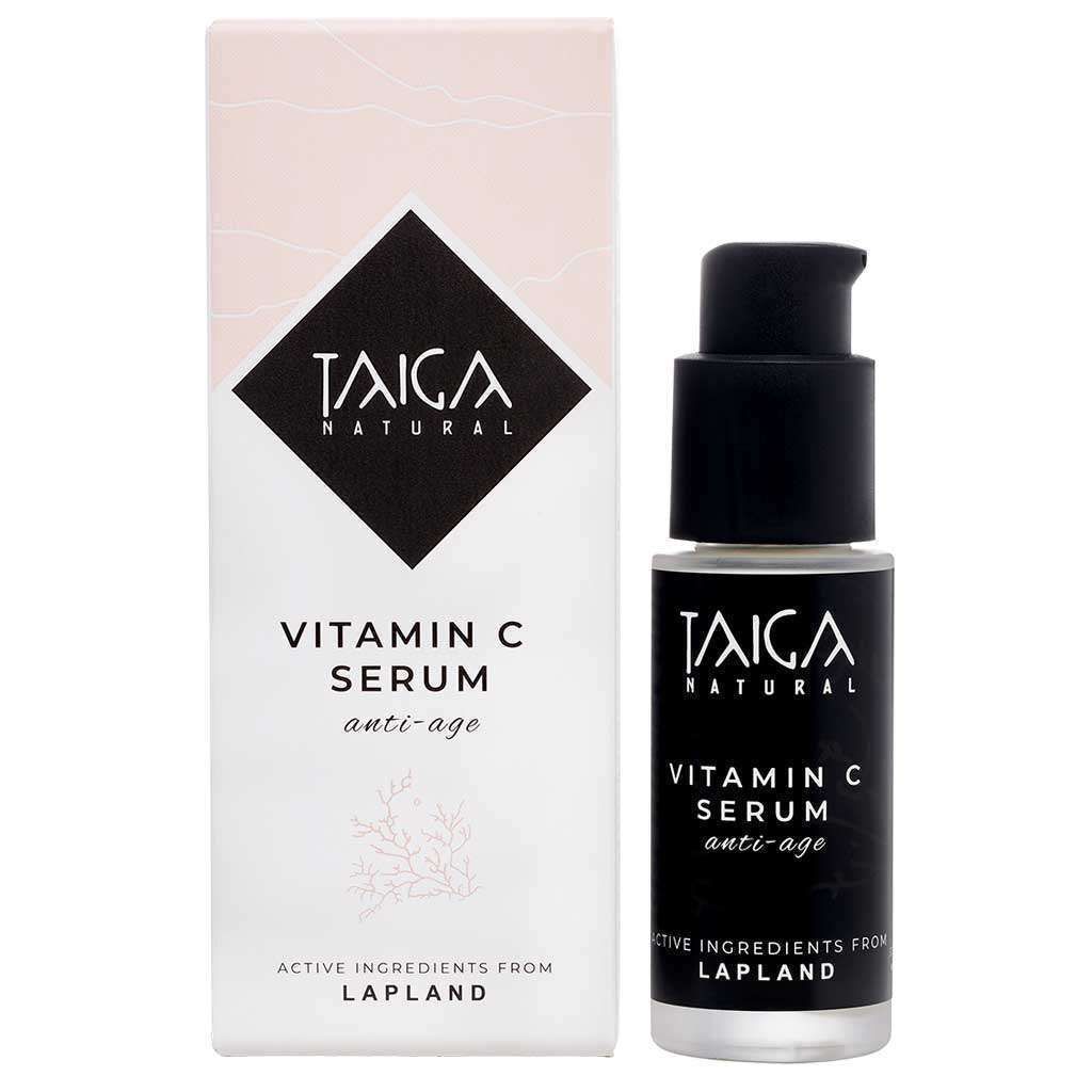 A bottle of Taiga Cosmetics Vitamin C Serum Anti-Age with a pump stands by its box. Both feature the Taiga Cosmetics brand and note firming, anti-ageing benefits with active ingredients sourced from Lapland.